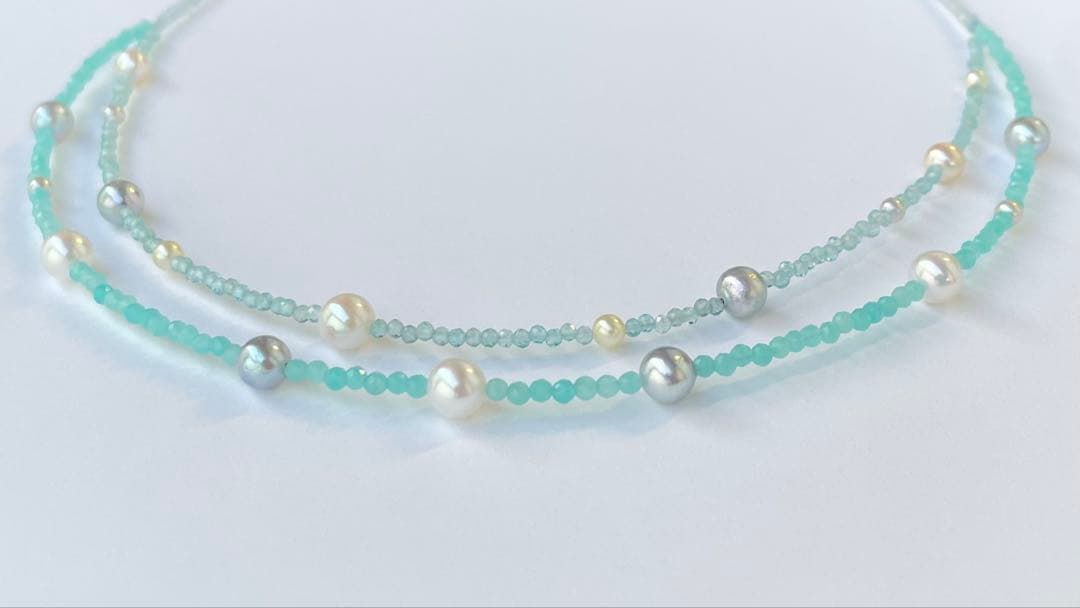 Akoya pearl layered necklace with 19 pearls in sea and sky colors showcasing transparency and unique design