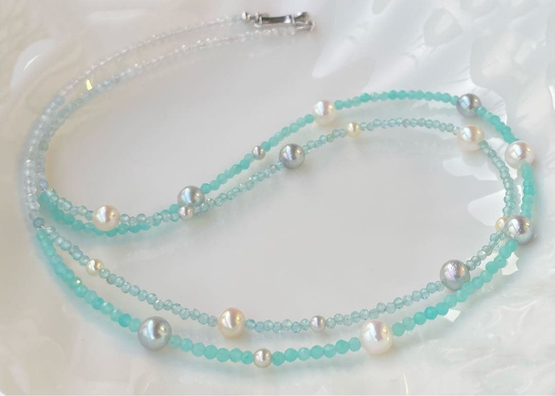 Akoya pearl layered necklace with 19 pearls in sea and sky colors showcasing transparency and unique design
