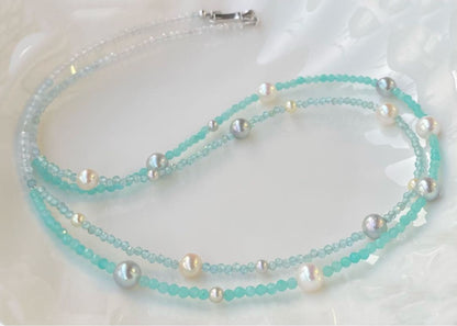 Akoya pearl layered necklace with 19 pearls in sea and sky colors showcasing transparency and unique design