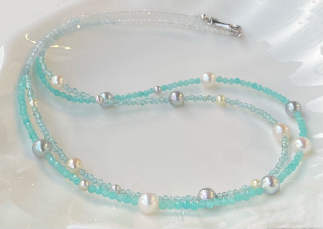 Akoya pearl layered necklace with 19 pearls in sea and sky colors showcasing transparency and unique design