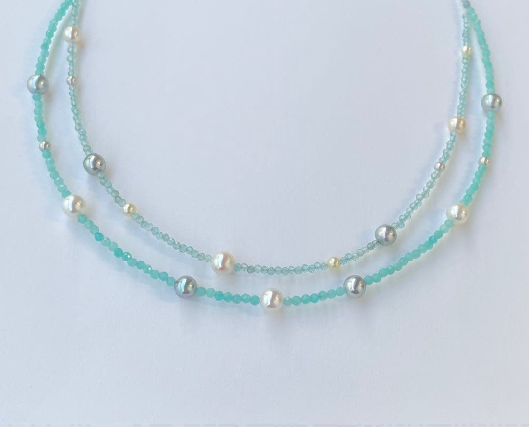 Akoya pearl layered necklace with 19 pearls in sea and sky colors showcasing transparency and unique design