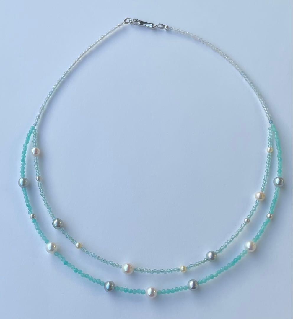 Akoya pearl layered necklace with 19 pearls in sea and sky colors showcasing transparency and unique design