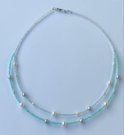 Akoya pearl layered necklace with 19 pearls in sea and sky colors showcasing transparency and unique design