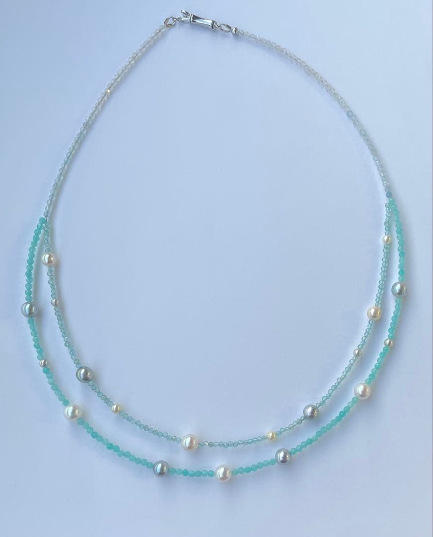 Akoya pearl layered necklace with 19 pearls in sea and sky colors showcasing transparency and unique design