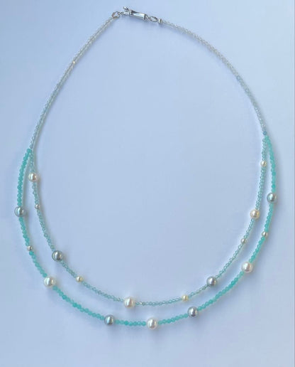 Akoya pearl layered necklace with 19 pearls in sea and sky colors showcasing transparency and unique design