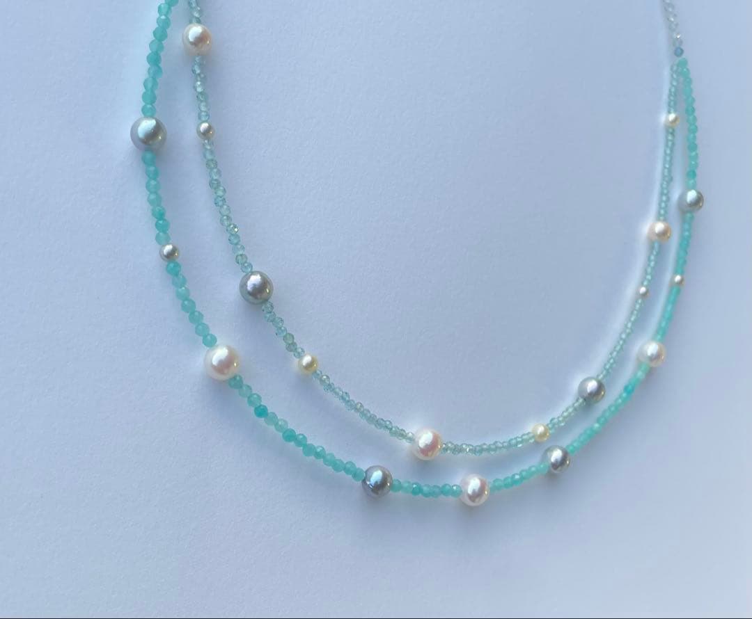 Akoya pearl layered necklace with 19 pearls in sea and sky colors showcasing transparency and unique design