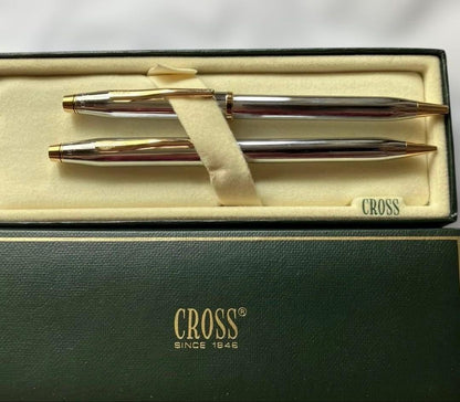 Cross ballpoint pen and mechanical pencil set with sleek silver finish on white background