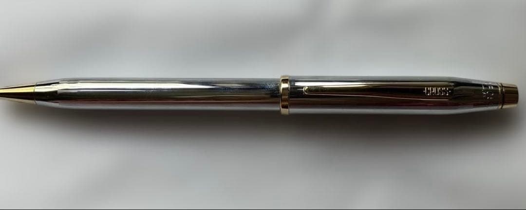 Cross ballpoint pen and mechanical pencil set with sleek silver finish on white background