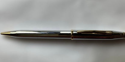 Cross ballpoint pen and mechanical pencil set with sleek silver finish on white background