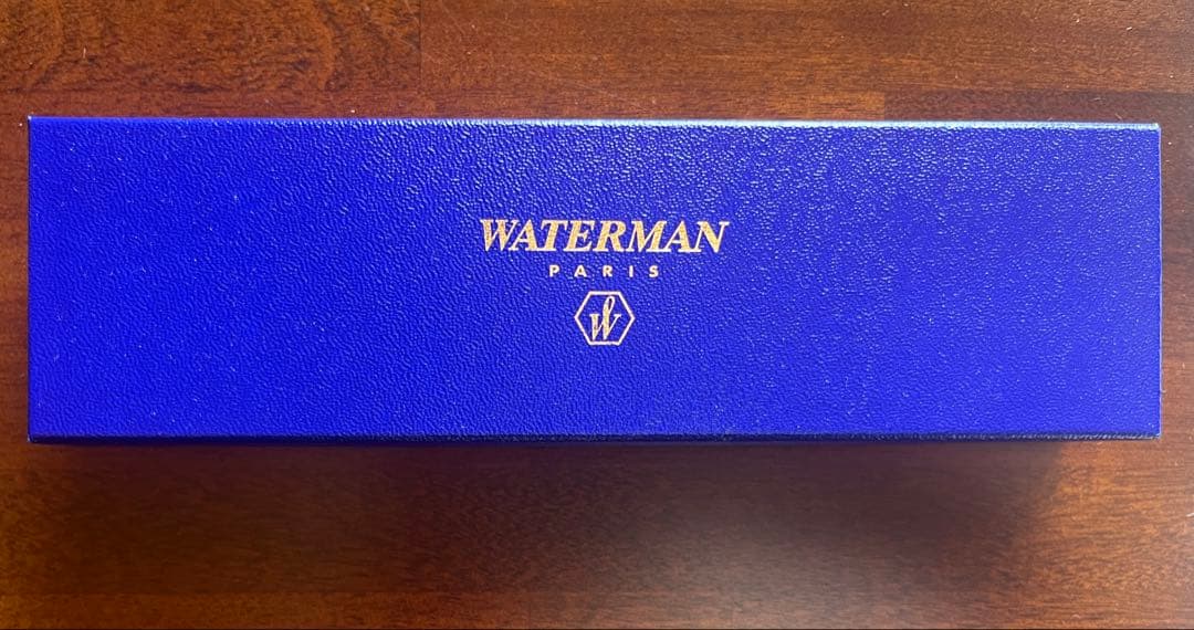 Silver WATERMAN PARIS ballpoint pen with slim body and clip on a white background