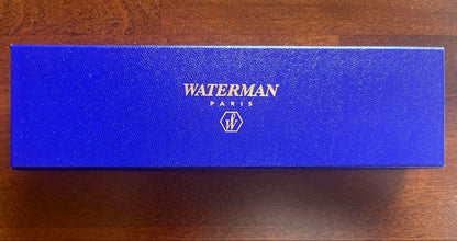 Silver WATERMAN PARIS ballpoint pen with slim body and clip on a white background