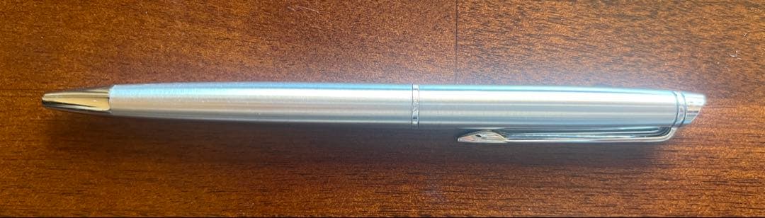 Silver WATERMAN PARIS ballpoint pen with slim body and clip on a white background