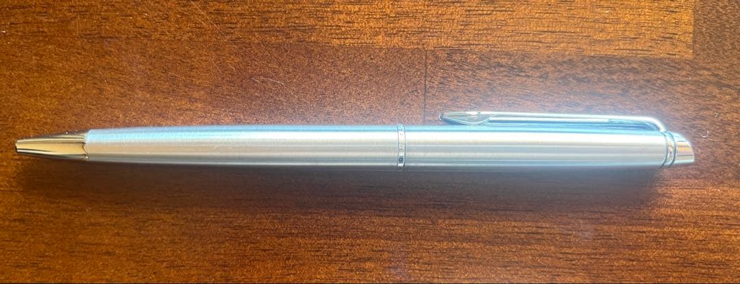 Silver WATERMAN PARIS ballpoint pen with slim body and clip on a white background