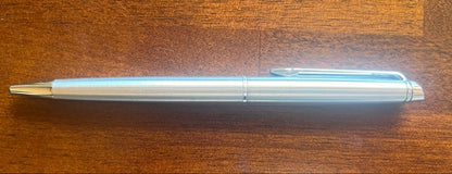 Silver WATERMAN PARIS ballpoint pen with slim body and clip on a white background