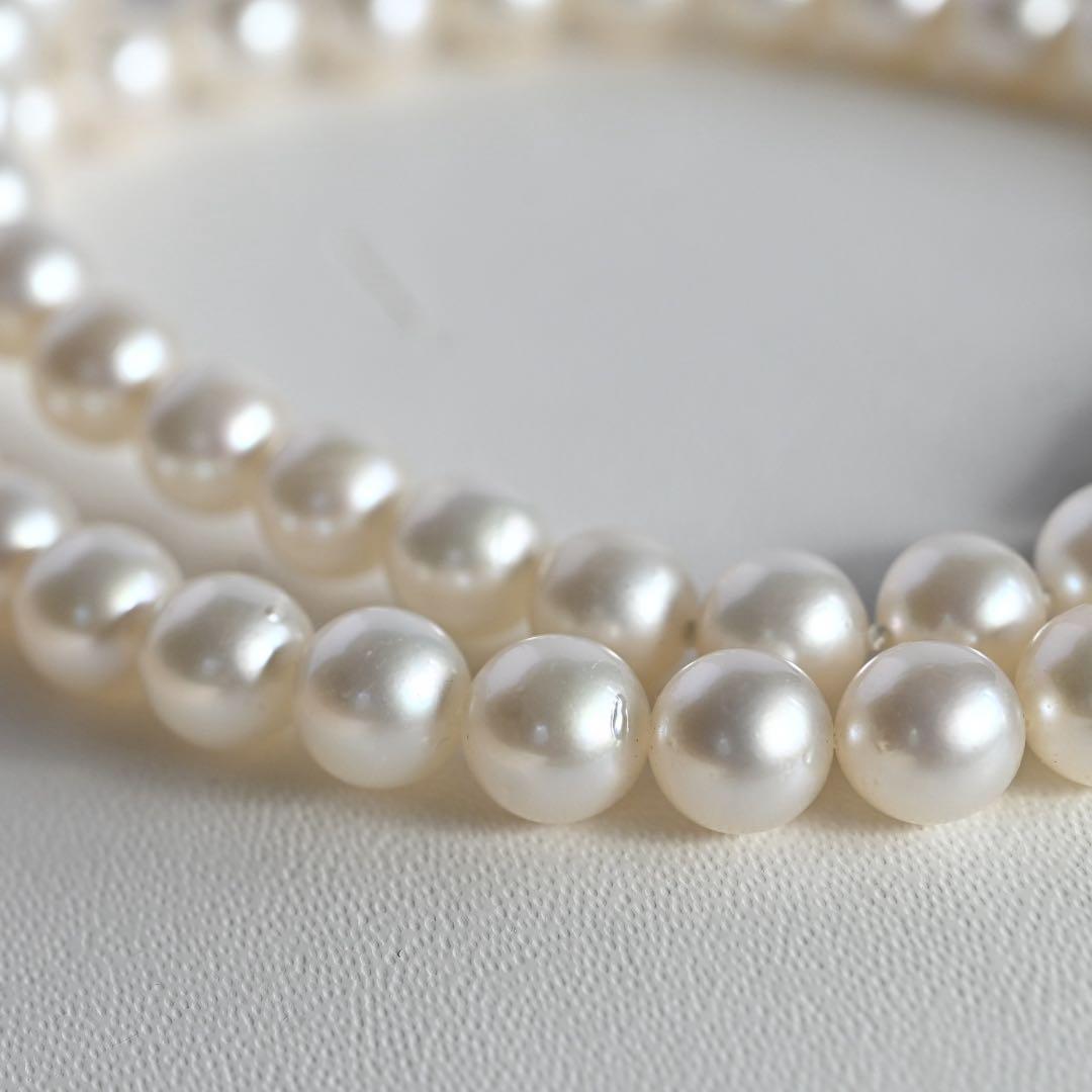 Tasaki Akoya Pearl Necklace featuring 7mm round pearls and a silver clasp on a white background