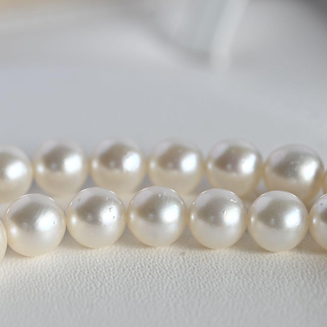Tasaki Akoya Pearl Necklace featuring 7mm round pearls and a silver clasp on a white background