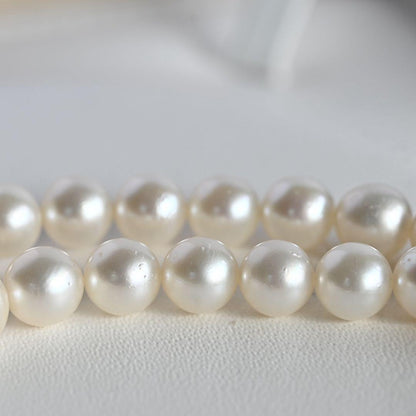 Tasaki Akoya Pearl Necklace featuring 7mm round pearls and a silver clasp on a white background