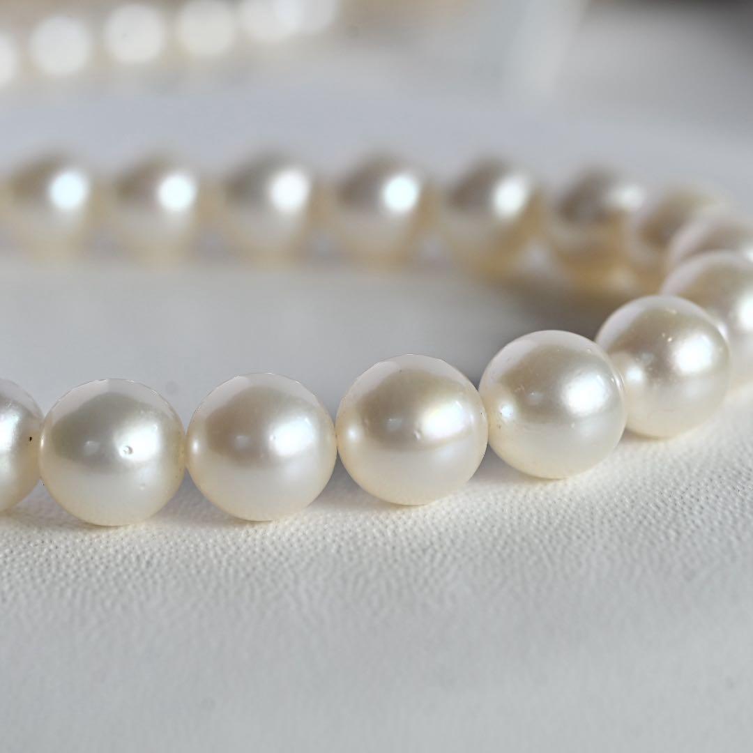 Tasaki Akoya Pearl Necklace featuring 7mm round pearls and a silver clasp on a white background