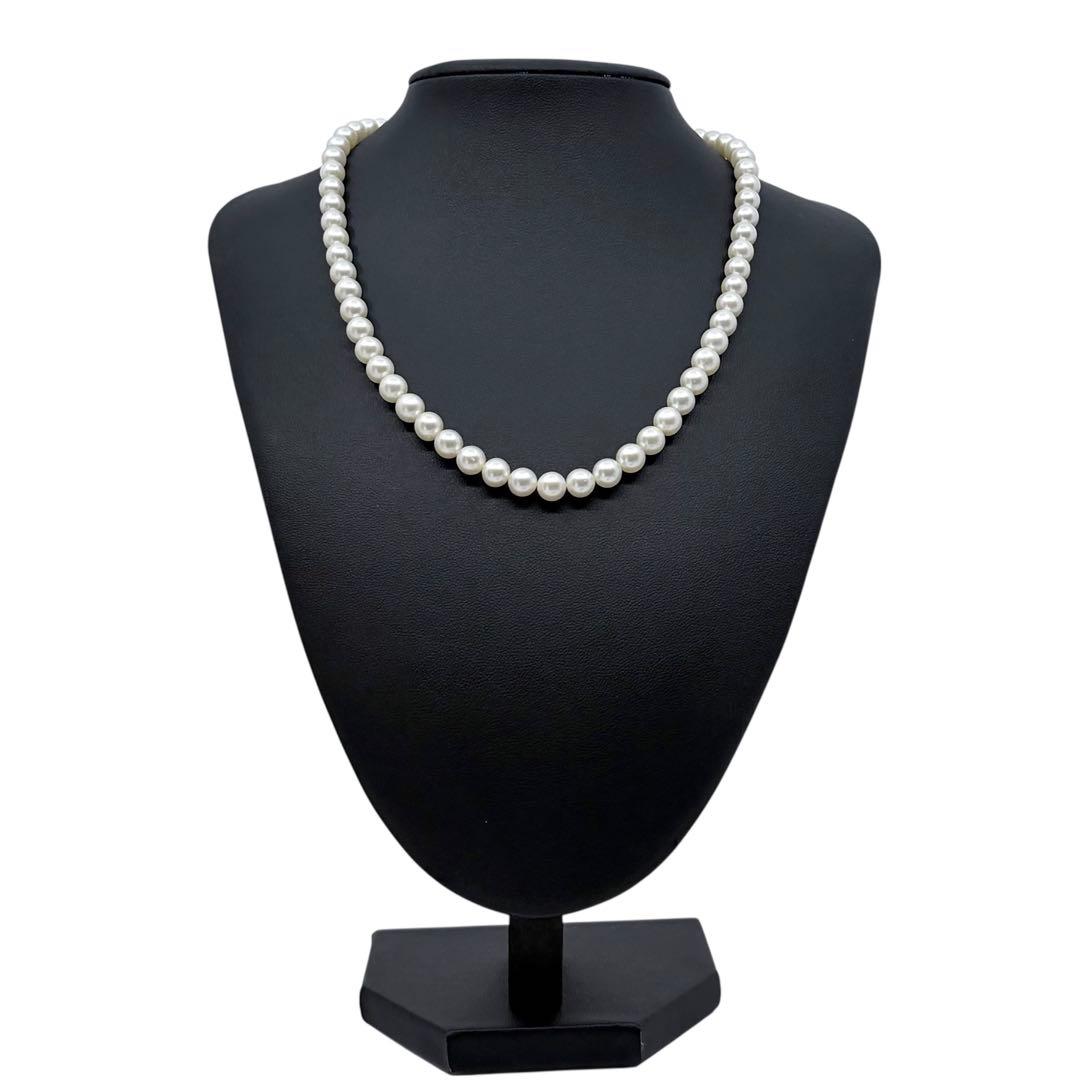 Tasaki Akoya Pearl Necklace featuring 7mm round pearls and a silver clasp on a white background