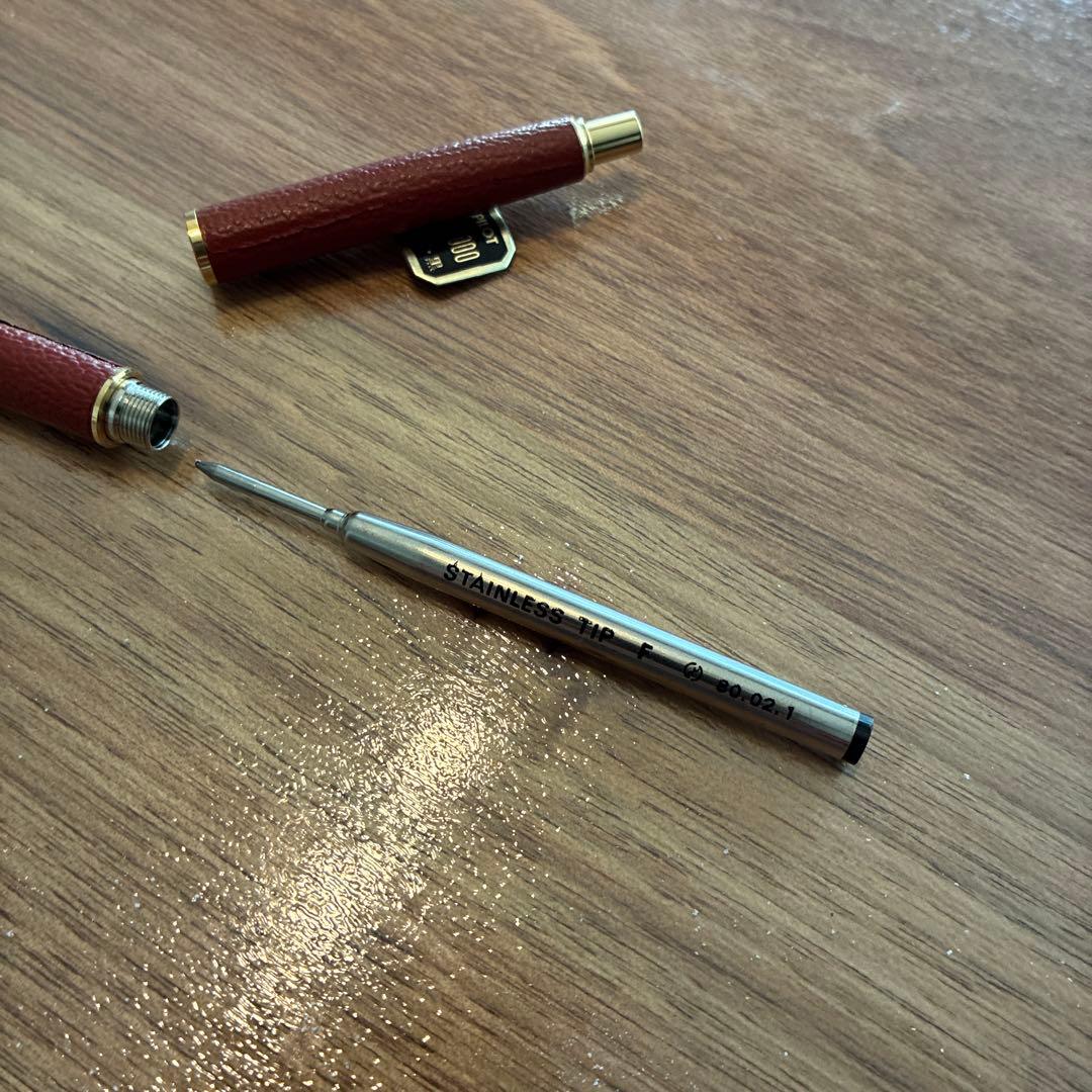 New PILOT high-end ballpoint pen with brown leather-like body and gold accents, fine point tip, black ink