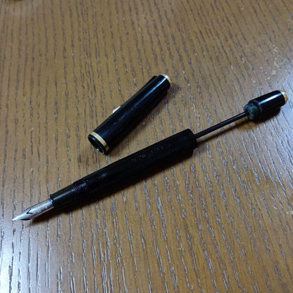 Vintage Pilot Plunger Fountain Pen with steel nib and slightly open clip on white background