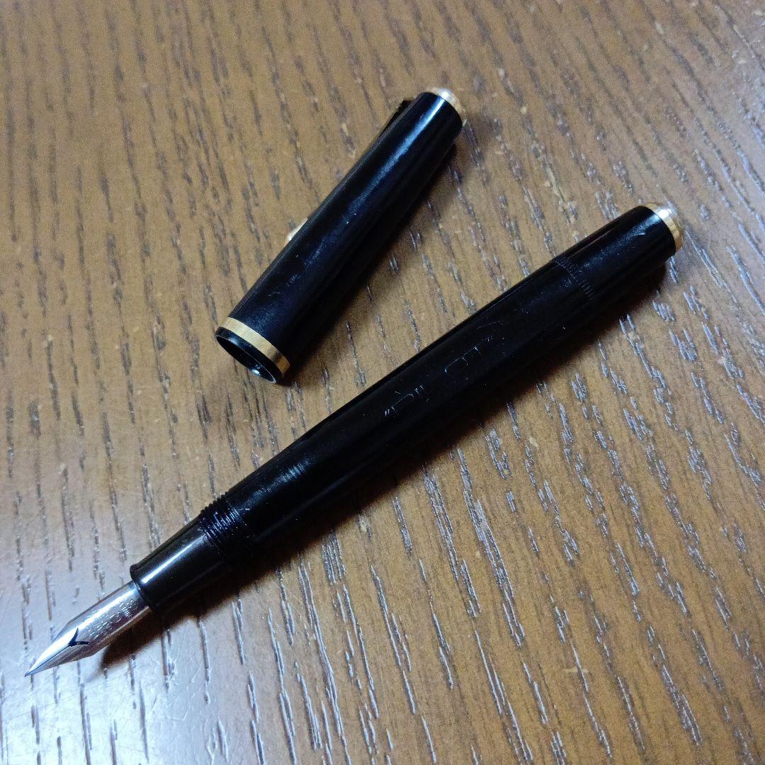 Vintage Pilot Plunger Fountain Pen with steel nib and slightly open clip on white background