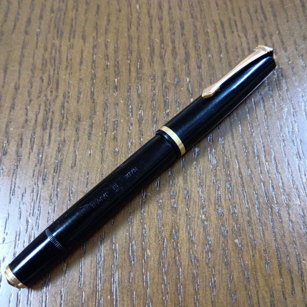 Vintage Pilot Plunger Fountain Pen with steel nib and slightly open clip on white background