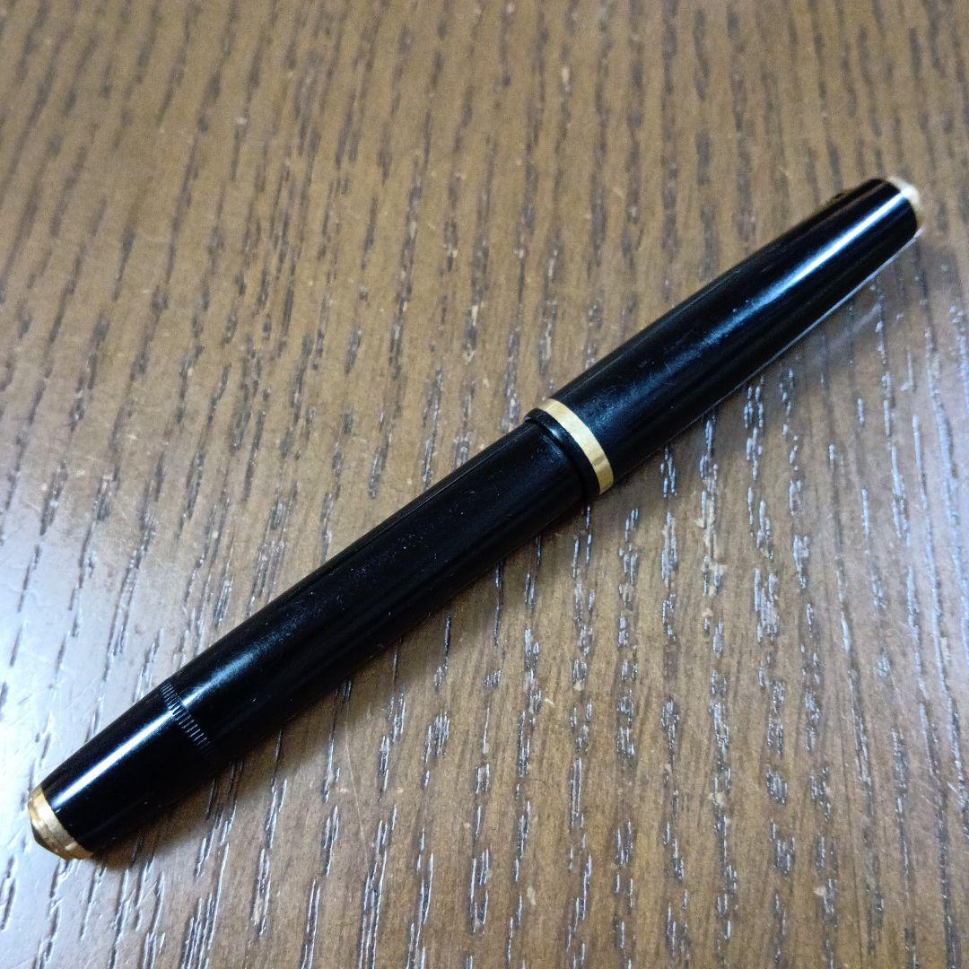 Vintage Pilot Plunger Fountain Pen with steel nib and slightly open clip on white background