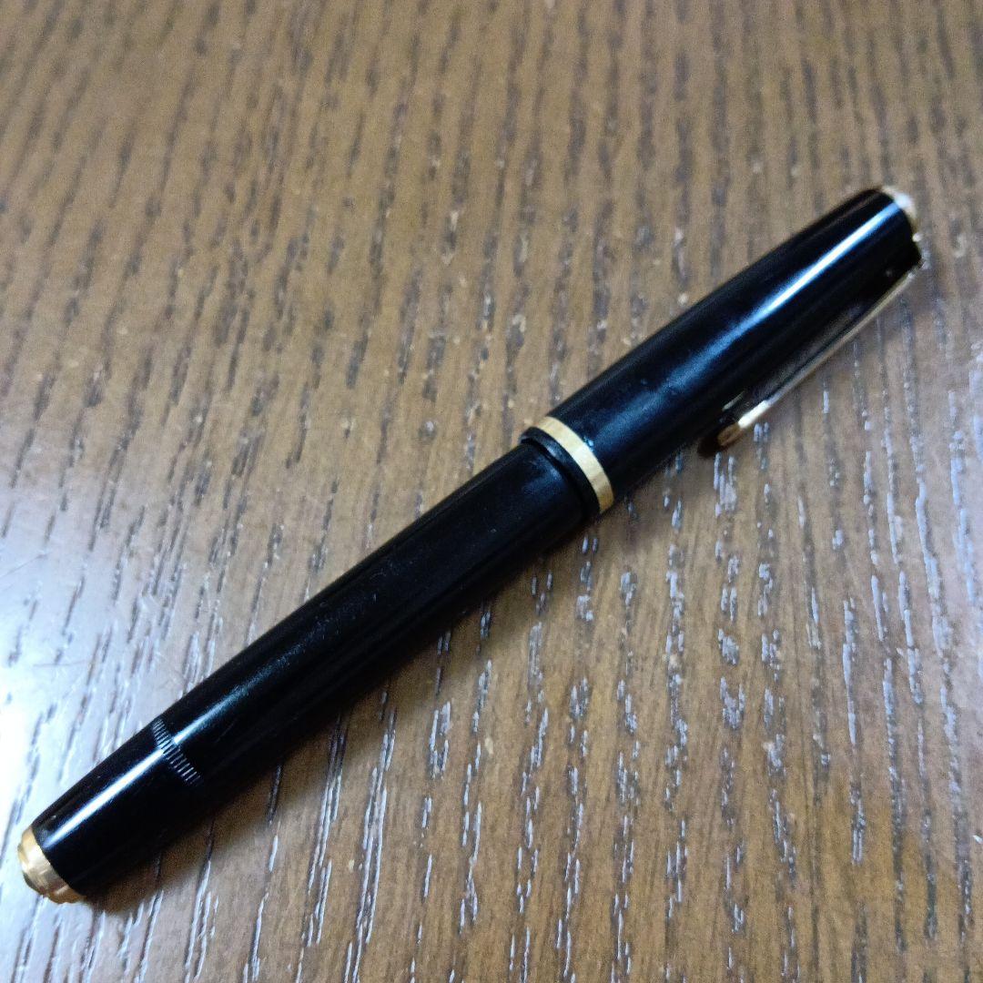 Vintage Pilot Plunger Fountain Pen with steel nib and slightly open clip on white background