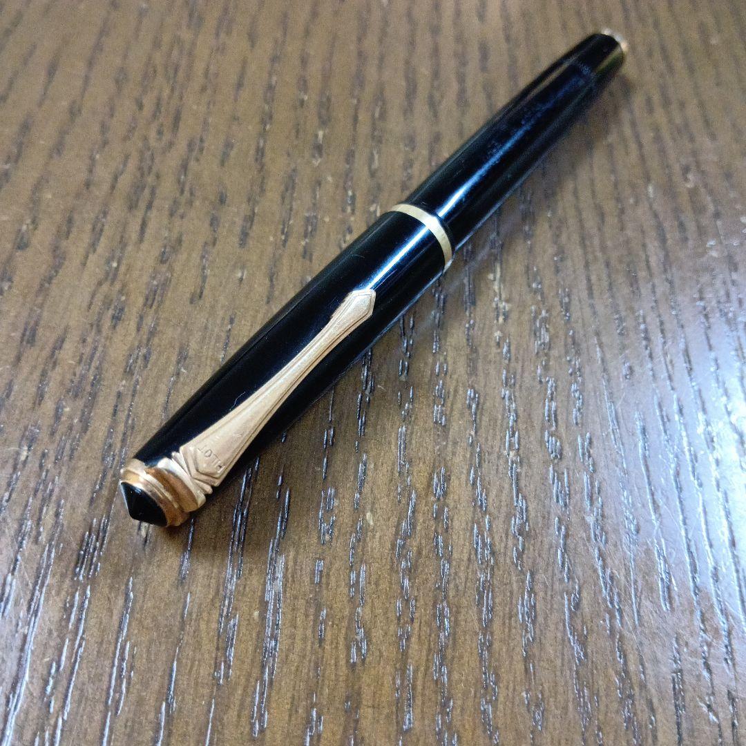 Vintage Pilot Plunger Fountain Pen with steel nib and slightly open clip on white background