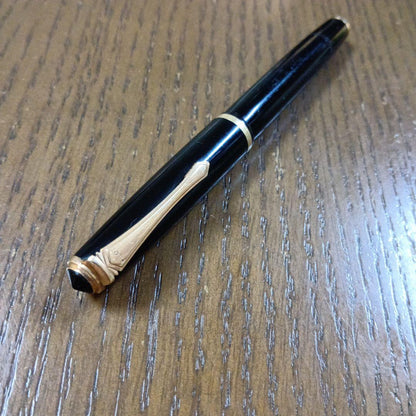 Vintage Pilot Plunger Fountain Pen with steel nib and slightly open clip on white background