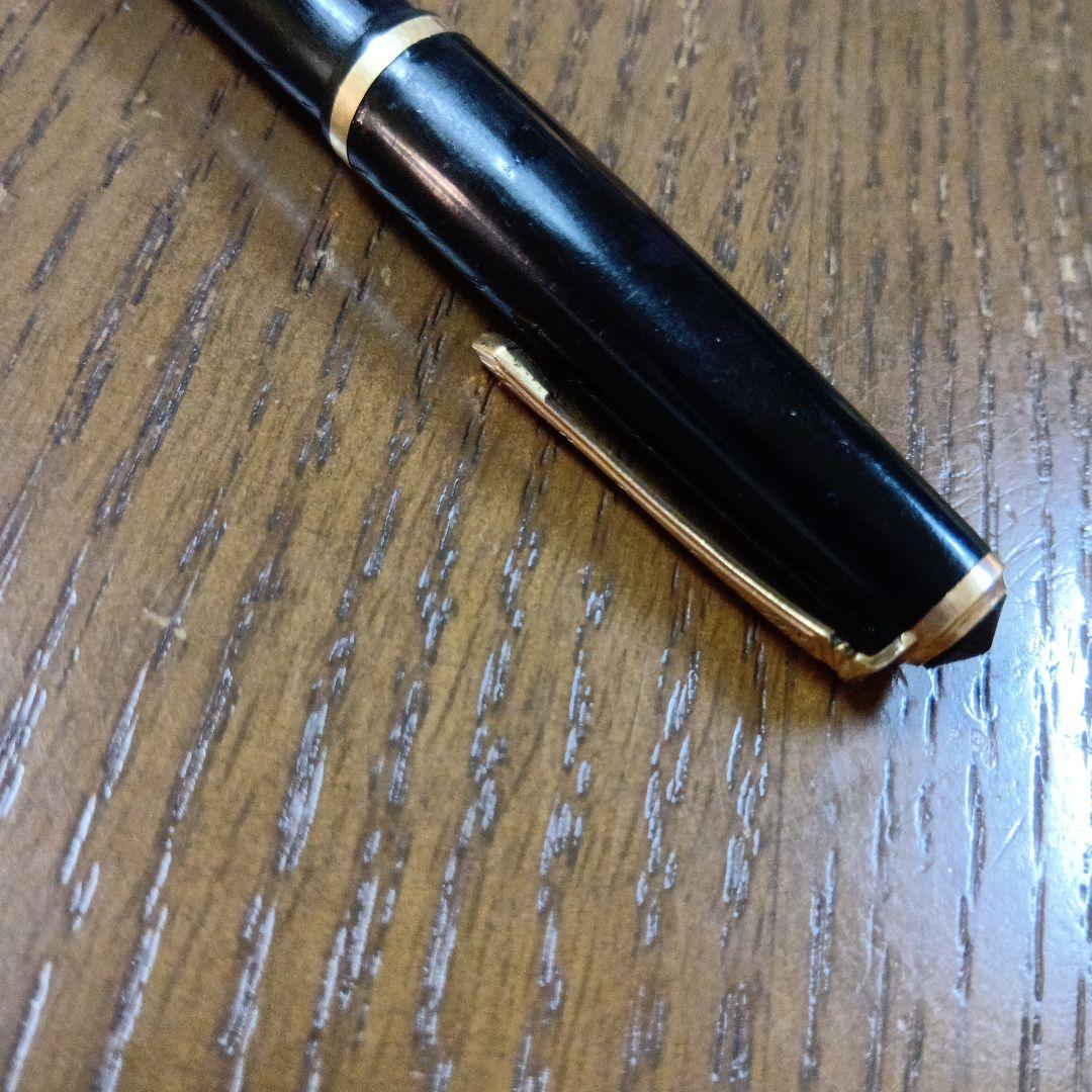 Vintage Pilot Plunger Fountain Pen with steel nib and slightly open clip on white background
