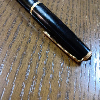 Vintage Pilot Plunger Fountain Pen with steel nib and slightly open clip on white background