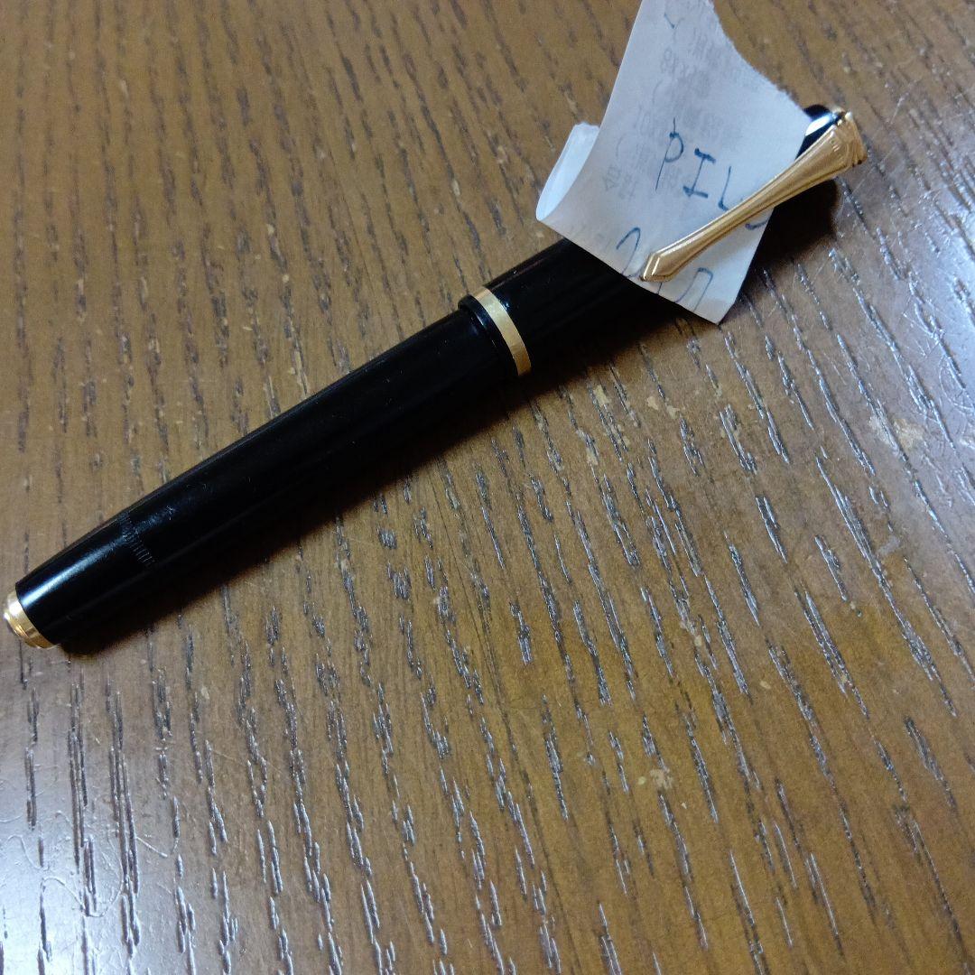 Vintage Pilot Plunger Fountain Pen with steel nib and slightly open clip on white background