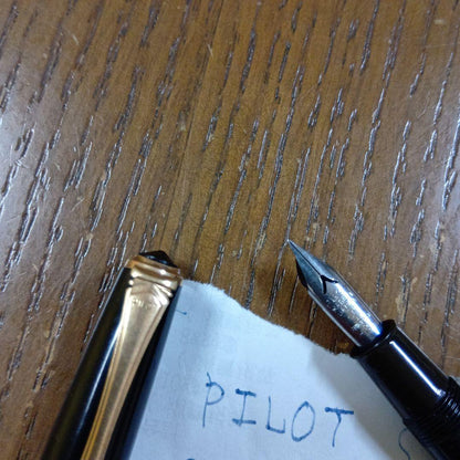 Vintage Pilot Plunger Fountain Pen with steel nib and slightly open clip on white background