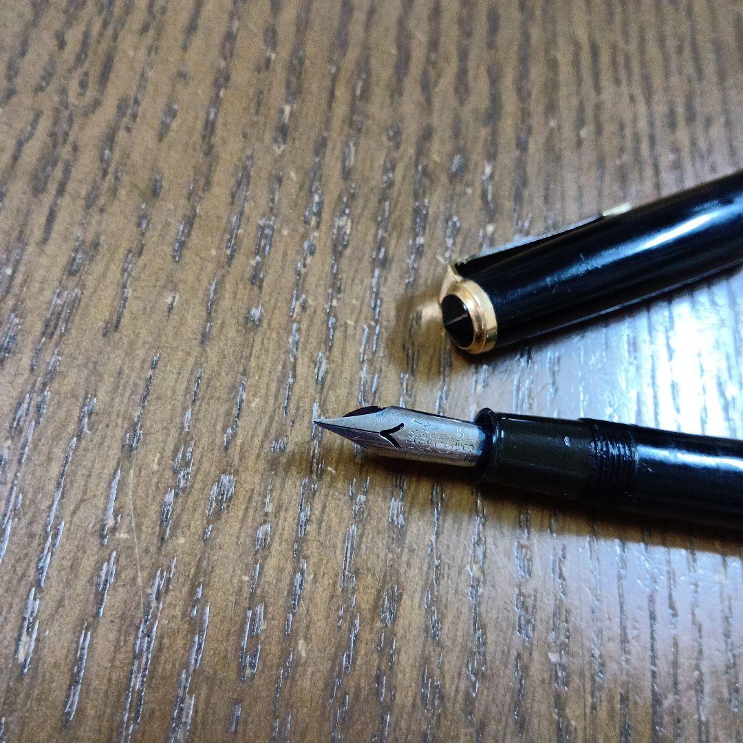 Vintage Pilot Plunger Fountain Pen with steel nib and slightly open clip on white background