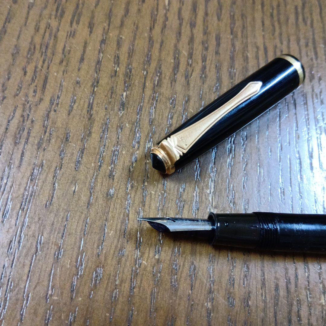Vintage Pilot Plunger Fountain Pen with steel nib and slightly open clip on white background
