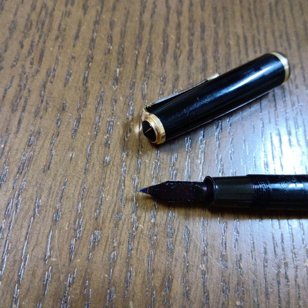 Vintage Pilot Plunger Fountain Pen with steel nib and slightly open clip on white background