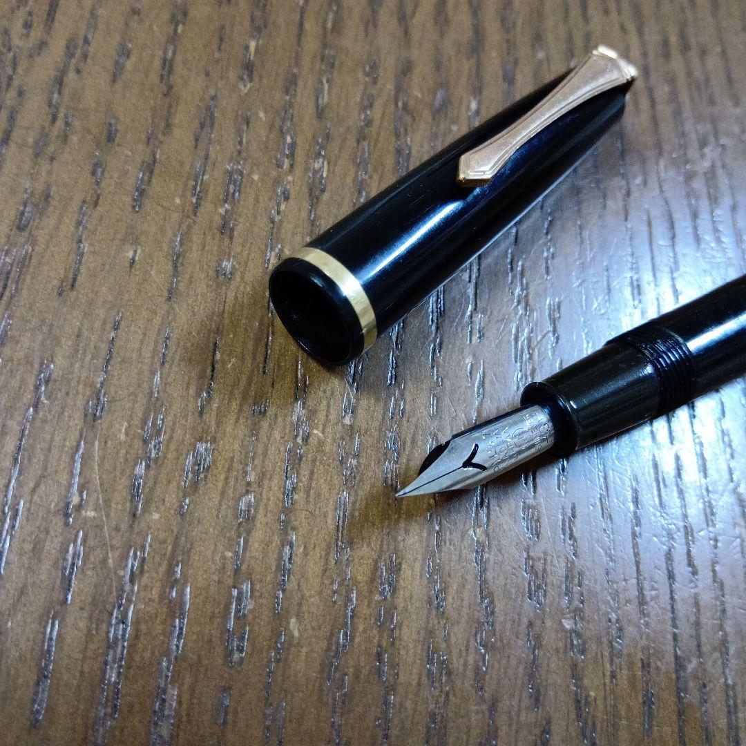 Vintage Pilot Plunger Fountain Pen with steel nib and slightly open clip on white background