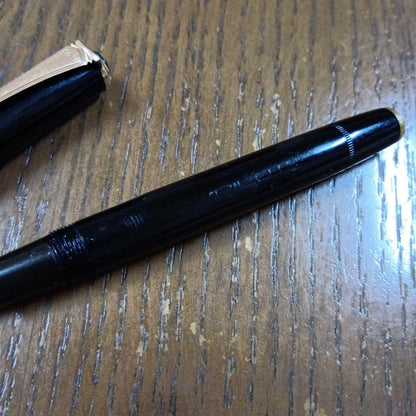 Vintage Pilot Plunger Fountain Pen with steel nib and slightly open clip on white background