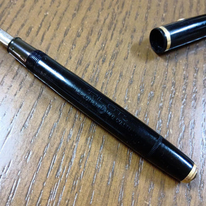 Vintage Pilot Plunger Fountain Pen with steel nib and slightly open clip on white background
