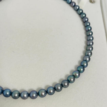 Akoya black pearl necklace with 7.5mm round peacock green pearls on a 43cm silver chain