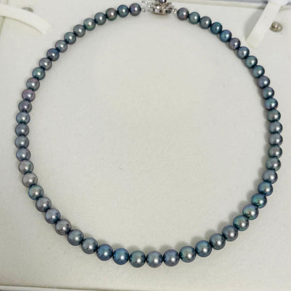 Akoya black pearl necklace with 7.5mm round peacock green pearls on a 43cm silver chain