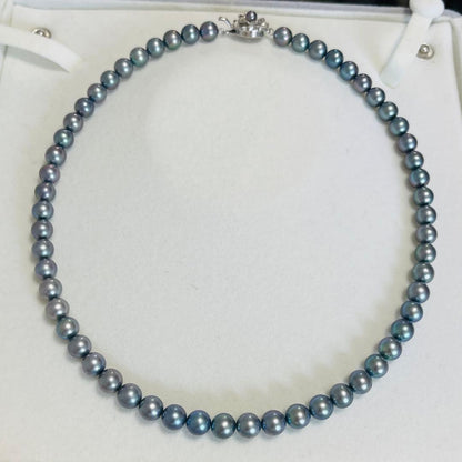 Akoya black pearl necklace with 7.5mm round peacock green pearls on a 43cm silver chain