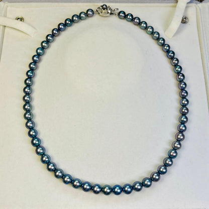 Akoya black pearl necklace with 7.5mm round peacock green pearls on a 43cm silver chain