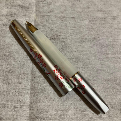 Showa Retro PILOT fountain pen with 14K nib, silver white barrel, red ornamented grip, and flower pattern design