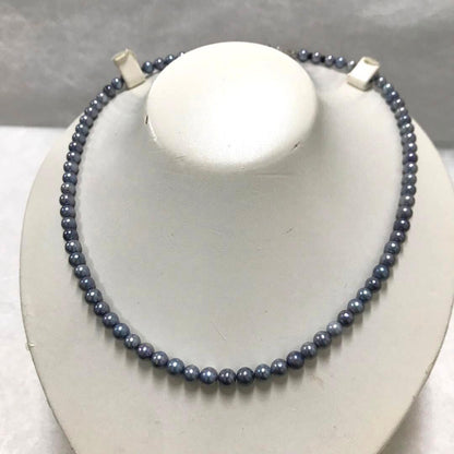 Akoya pearl necklace with small round blue-grey pearls on a 40cm strand with sterling silver clasp