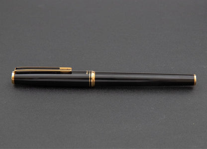 Pilot fountain pen with 14k gold fine nib, black and gold body, and blue-black ink cartridge included