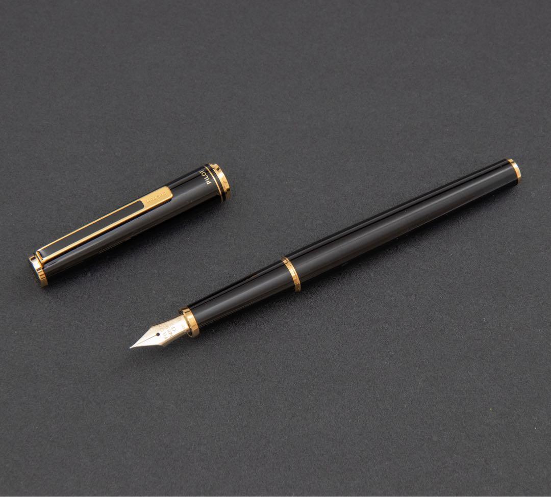 Pilot fountain pen with 14k gold fine nib, black and gold body, and blue-black ink cartridge included