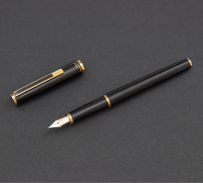 Pilot fountain pen with 14k gold fine nib, black and gold body, and blue-black ink cartridge included